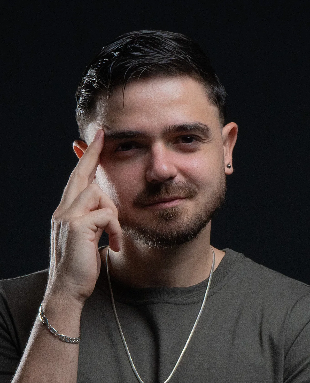 Portrait of João Brugger in low-key studio light against black